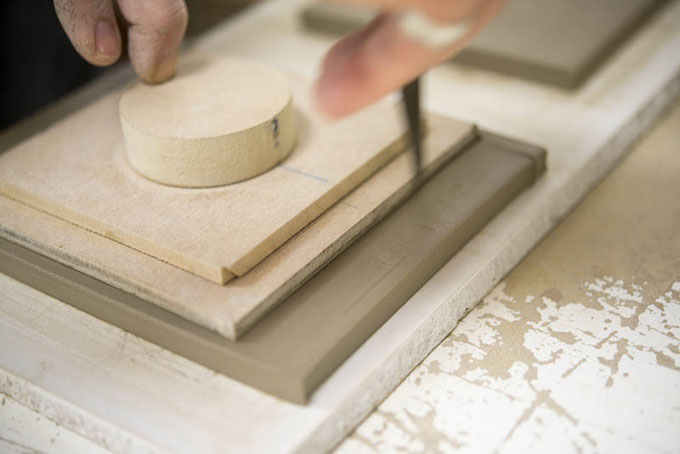 Tile making at Douglas Watson Studios - Dr Pete Spring hand cutting the tile blanks