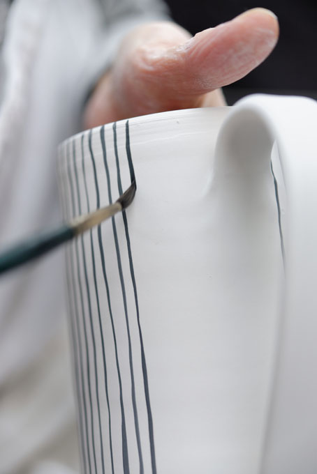 Sue Binns decorating in her studio in London 2013 - Cobalt is applied over a matt glaze.