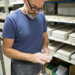 Tile making at Douglas Watson Studios - Dr Pete Spring hand cutting the tile blanks