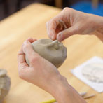Sally MacDonell demonstrating the building of a face at Oxford Ceramics Fair 2013