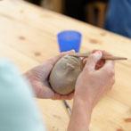 Sally MacDonell demonstrating the building of a face at Oxford Ceramics Fair 2013