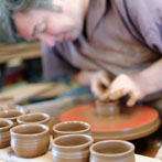 Paul Jessop at Barrington Pottery 2014 making small sauce pots