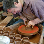 Paul Jessop at Barrington Pottery 2014 making small sauce pots
