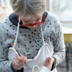 Sue Binns decorating in her studio in London 2013 - Cobalt is applied over a matt glaze.