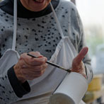 Sue Binns decorating in her studio in London 2013 - Cobalt is applied over a matt glaze.
