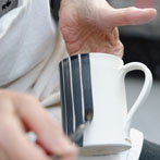 Sue Binns decorating in her studio in London 2013 - Cobalt is applied over a matt glaze.