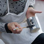Sue Binns decorating in her studio in London 2013 - Cobalt is applied over a matt glaze.