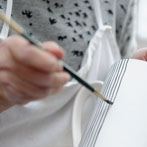 Sue Binns decorating in her studio in London 2013 - Cobalt is applied over a matt glaze.