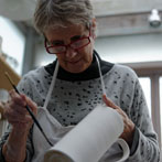 Sue Binns decorating in her studio in London 2013 - Cobalt is applied over a matt glaze.
