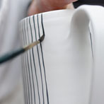 Sue Binns decorating in her studio in London 2013 - Cobalt is applied over a matt glaze.