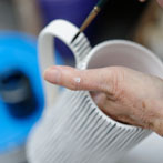 Sue Binns decorating in her studio in London 2013 - Cobalt is applied over a matt glaze.
