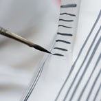 Sue Binns decorating in her studio in London 2013 - Cobalt is applied over a matt glaze.