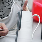 Sue Binns decorating in her studio in London 2013 - Cobalt is applied over a matt glaze.