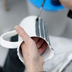 Sue Binns decorating in her studio in London 2013 - Cobalt is applied over a matt glaze.