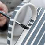 Sue Binns decorating in her studio in London 2013 - Cobalt is applied over a matt glaze.