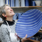 Sue Binns decorating in her studio in London 2013 - Cobalt is applied over a matt glaze.