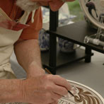 Laurence McGowan decorating a plate