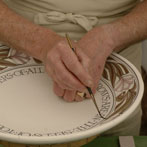 Laurence McGowan decorating a plate