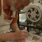 Laurence McGowan decorating a plate